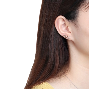 Close-up of elegant rose gold double heart stud earrings with pavé set crystals on model