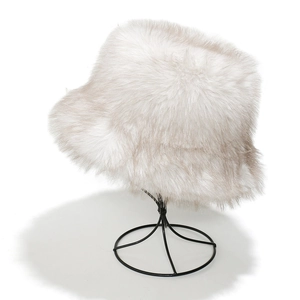 Detailed texture of thick faux fox fur winter bucket hat in light grey and beige