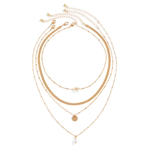 Detail of four-piece layered gold necklace set with daisy, pearl, and snake chain style