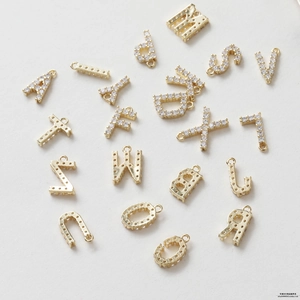 Detail of 14K gold plated alphabet pendants with cubic zirconia for DIY jewelry making