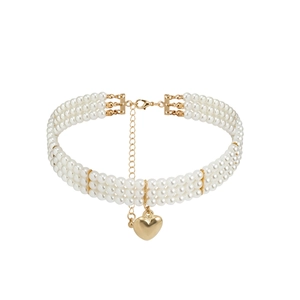Close-up of triple-layer pearl choker with a polished gold heart pendant and lobster clasp