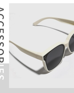 Close-up detail of trendy cream-white square frame sunglasses with dark grey lenses