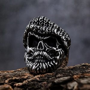 Macro view of vintage silver skull ring with detailed beard and knit hat engraving