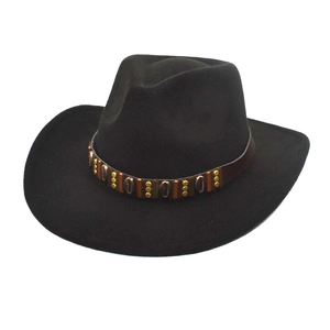 Classic black wool felt cowboy hat with vintage bronze studded decorative band on white background