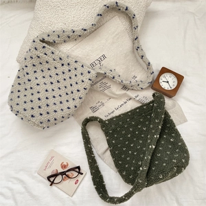 Close-up of fuzzy teddy fleece tote bags with polka dot patterns and soft texture
