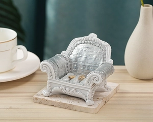 European vintage sofa jewelry stand with silver silk cushion and gold floral earrings