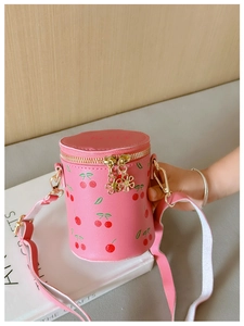 Detailed shot of pink cherry print kids bucket bag with cute flower zipper pullers
