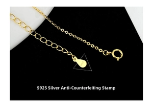 Macro shot of gold S925 sterling silver extender chain and droplet pendant with hallmark