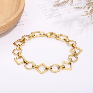 Close-up of polished gold geometric link bracelet with square and scalloped circle rings