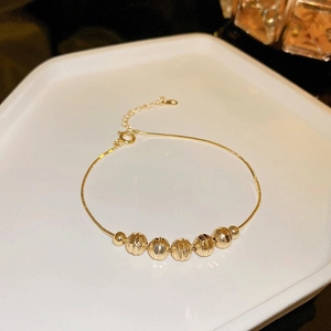 Minimalist gold snake chain bracelet with five faceted beads and adjustable clasp