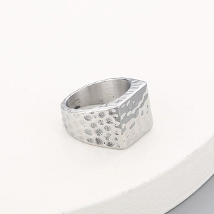 Detailed view of hammered texture and stainless steel engraving on vintage square ring