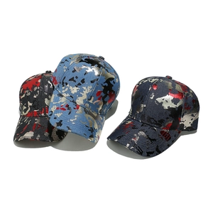 Three metallic camouflage baseball hats in black, red, and blue with shiny gold foil finish