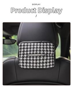 Detail of houndstooth knit tissue box cover mounted on car headrest with velcro strap