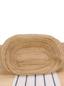 Close-up of a large woven straw tote bag with intricate texture for beach and daily commute