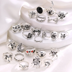 24-piece vintage punk ring set with skull and spider motifs on a white silk base