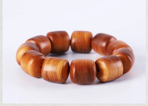 Macro detail of natural Thuja sutchuenensis wood beads with distinct aged grain textures