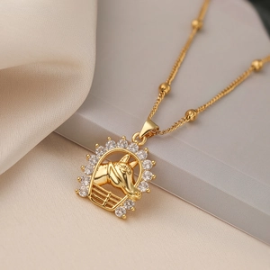 Gold tree of life necklace with horse and fence pendant featuring sparkling zircon crystals