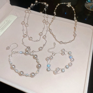 Close-up of French rose pearl necklace and bracelet set in a pink velvet jewelry box