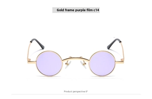 Detail view of retro small round steampunk sunglasses with gold metal frame and purple lens