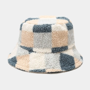 Detail of blue and beige plaid bucket hat showing soft faux shearling wool texture