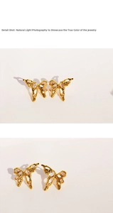 Macro shot of liquid metal butterfly earrings with zircons and textured golden finish