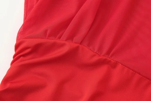 Detailed close-up of red mesh stitching and premium fabric texture on fashion dress