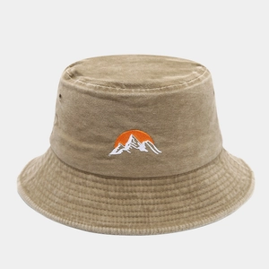 Close-up of embroidered mountain and sun pattern on a khaki washed cotton bucket hat