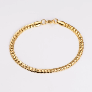 Detailed close-up of a gold-plated stainless steel flat link chain bracelet with spring clasp