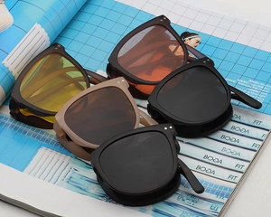 Detailed top view of various colored oval sunglasses with metal rivet decorations