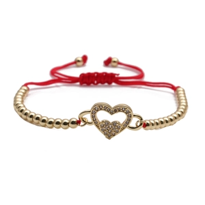 Adjustable red string bracelet featuring a gold heart pendant with cubic zirconia stones