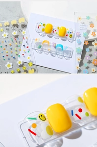 Macro detail of 3D thin nail art stickers featuring colorful smiles and floral patterns