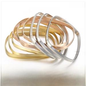 Detail view of 6mm brushed stainless steel bangles in gold, rose gold and silver colors