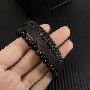 Detail of multi-layer braided leather bracelet with natural red tiger eye beads for men