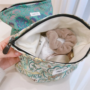 Detail view of jacquard makeup bags showing spacious interior and premium floral texture