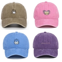 Detail view of four vintage washed cotton baseball caps with colorful cartoon embroidery