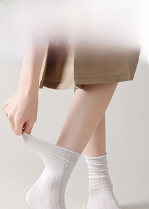 Detail of white mesh socks with reinforced heel and non-slip design for women