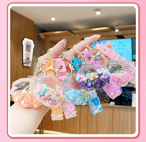 Detail of shell-shaped liquid glitter keychains with colorful beads and sequins