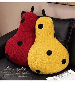 Detail of red and yellow pear plush pillows with soft granule velvet fabric on sofa