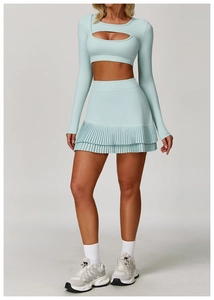 Detail of mint green pleated tennis skirt with high waist design and layered hemline