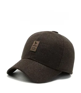 Detail of winter baseball cap with warm ear flaps and brown leather sport patch