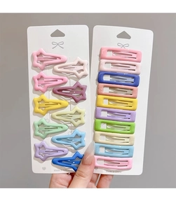Macro view of candy-colored star and rectangular metal snap hair clips for girls