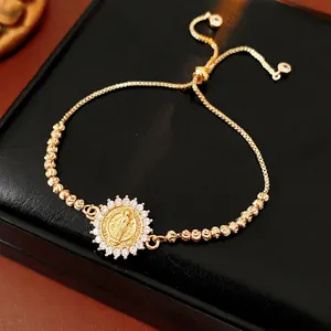 Adjustable gold Virgin Mary medallion bracelet with white zircon pave on black box