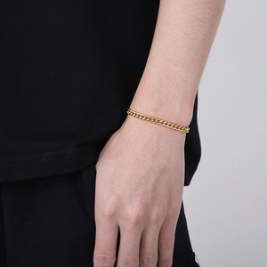 Macro detail of gold Cuban link bracelet with OT toggle clasp and polished finish