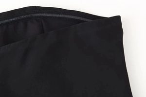 Detailed macro view of internal non-slip silicone strips on black strapless dress