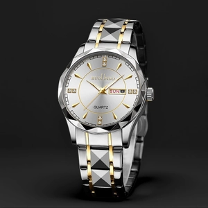 Detail of multi-faceted glass and dual calendar display on men's steel quartz watch