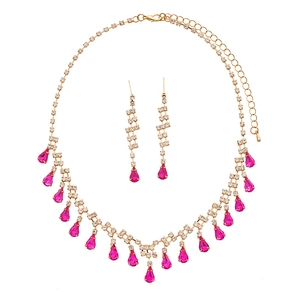 Golden necklace and earring set with sparkling crystals and pink teardrop gems