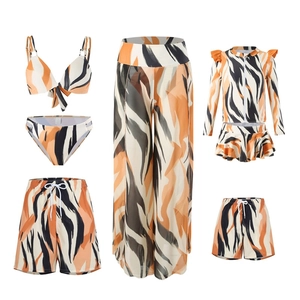 Family matching swimsuits with orange and black tiger print for parents and children