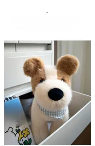 Detail of plush fox terrier toy with blue checkered bib in a cozy home setting