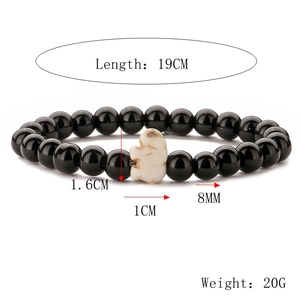 Detail view of 8mm black beads bracelet with white elephant charm and size specifications