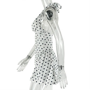 Detail of white polka dot dress with halter neck tie and functional side pocket